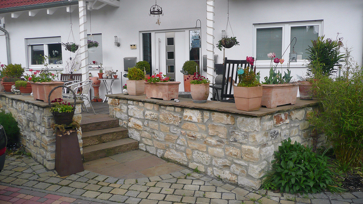 Terrasse und Hauseingang mit hellen Natursteinen